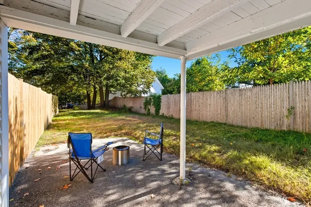 a view of a chairs in backyard of the house