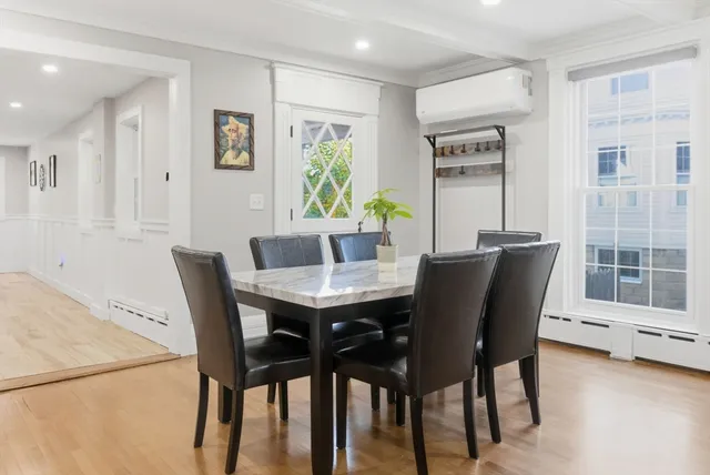 a view of a dining room with furniture and window