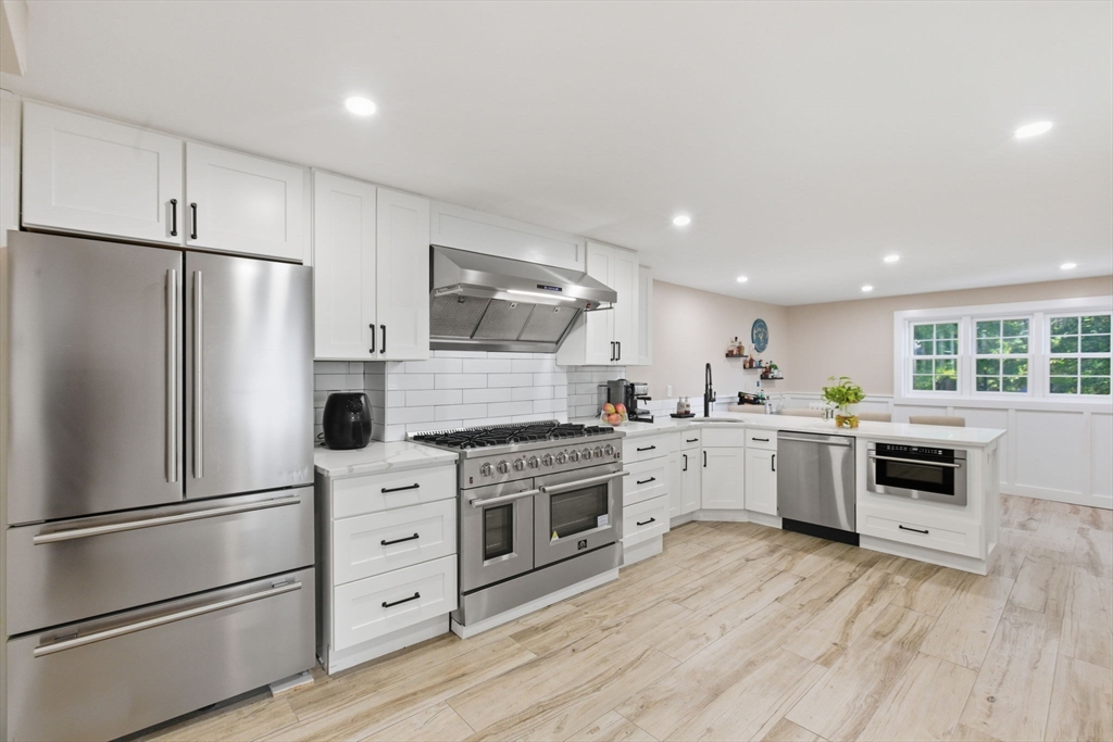 12 Salem Street, Unit 2 Haverhill, MA 01835 - Photo 9 of 34 a kitchen with white cabinets stainless steel appliances and window