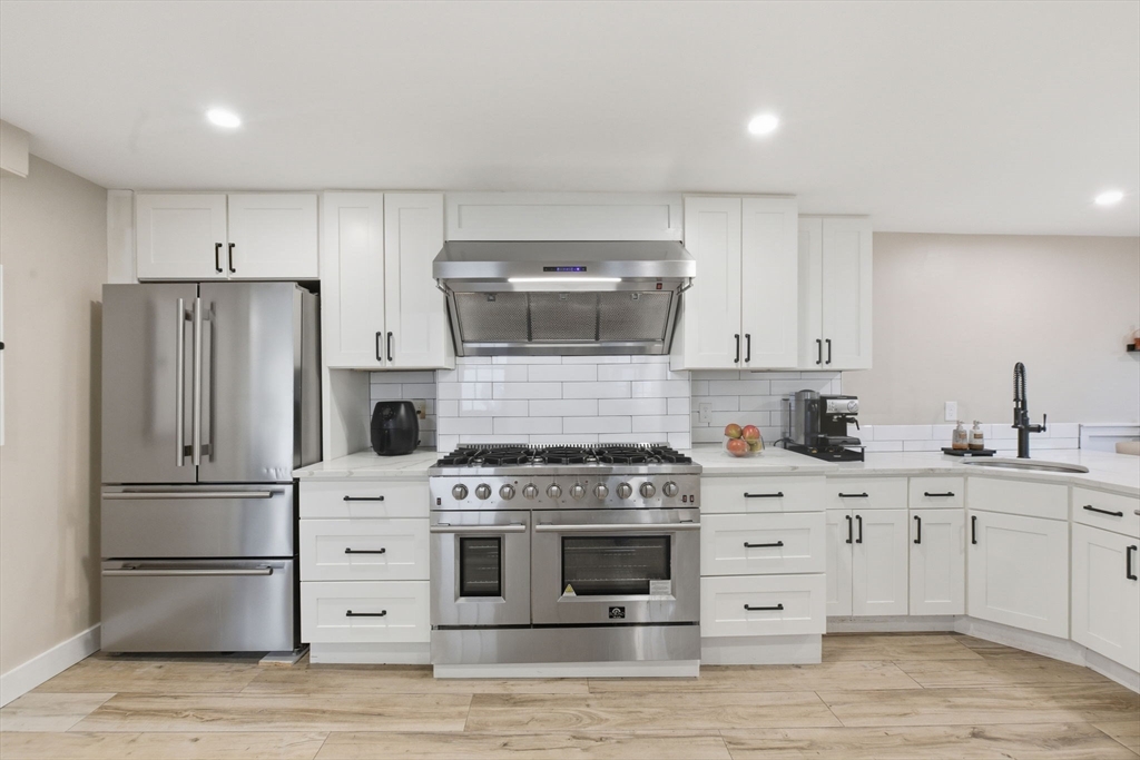 12 Salem Street, Unit 2 Haverhill, MA 01835 - Photo 10 of 34 a kitchen with cabinets stainless steel appliances and wooden floor