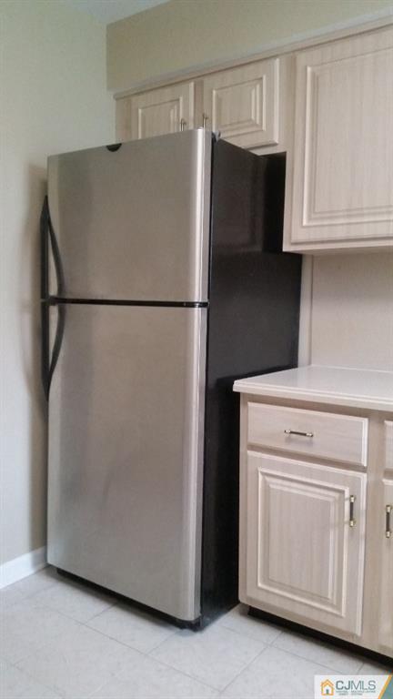 8305 Hana Road Edison, NJ 08817 - Photo 12 of 20 a white refrigerator freezer and a stove sitting inside of a kitchen