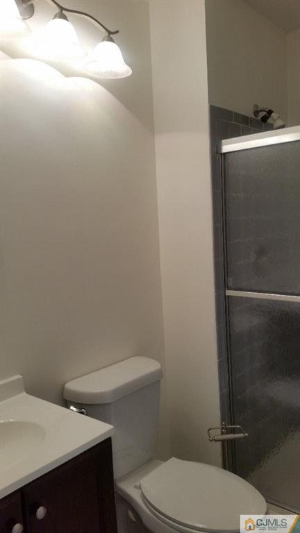 8305 Hana Road Edison, NJ 08817 - Photo 16 of 20 a bathroom with a toilet and a sink