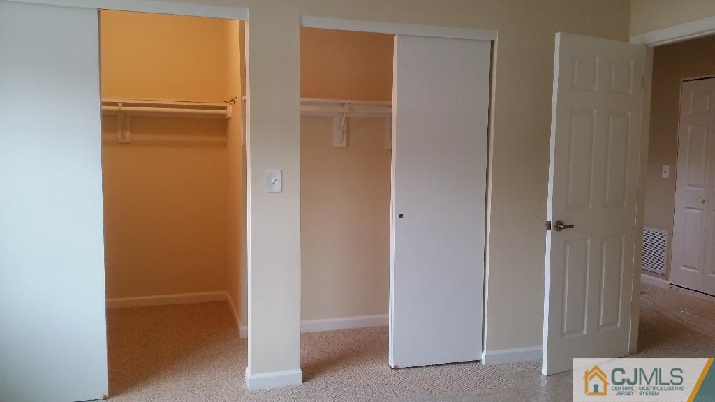 8305 Hana Road Edison, NJ 08817 - Photo 18 of 20 a view of walk in closet with empty racks
