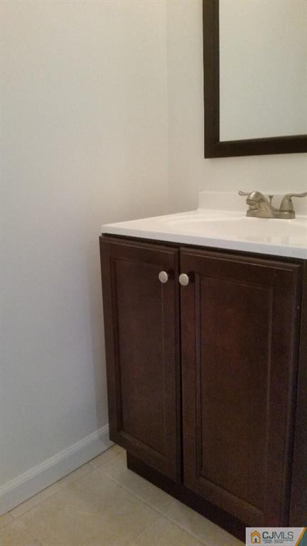 8305 Hana Road Edison, NJ 08817 - Photo 19 of 20 a bathroom with a sink vanity and a mirror
