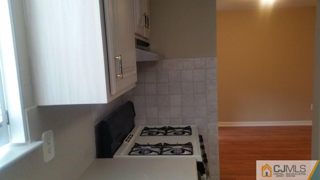 8305 Hana Road Edison, NJ 08817 - Photo 10 of 20 a kitchen with a stove and a refrigerator