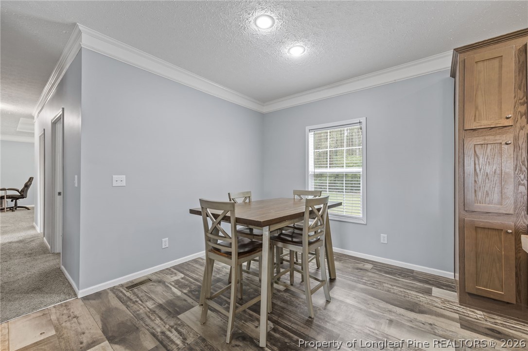 2252 Old Stage Road South Erwin, NC 28339 - Photo 10 of 47 a view of a dining room with furniture and a chandelier