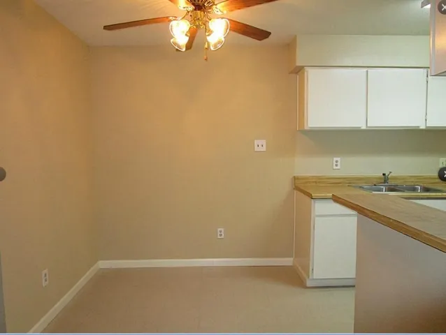 an empty room with a sink and a window