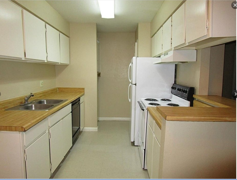 2200 Cypress Landing Road, Unit F3 Houston, TX 77090 - Photo 5 of 7 a kitchen with a sink a stove and a refrigerator