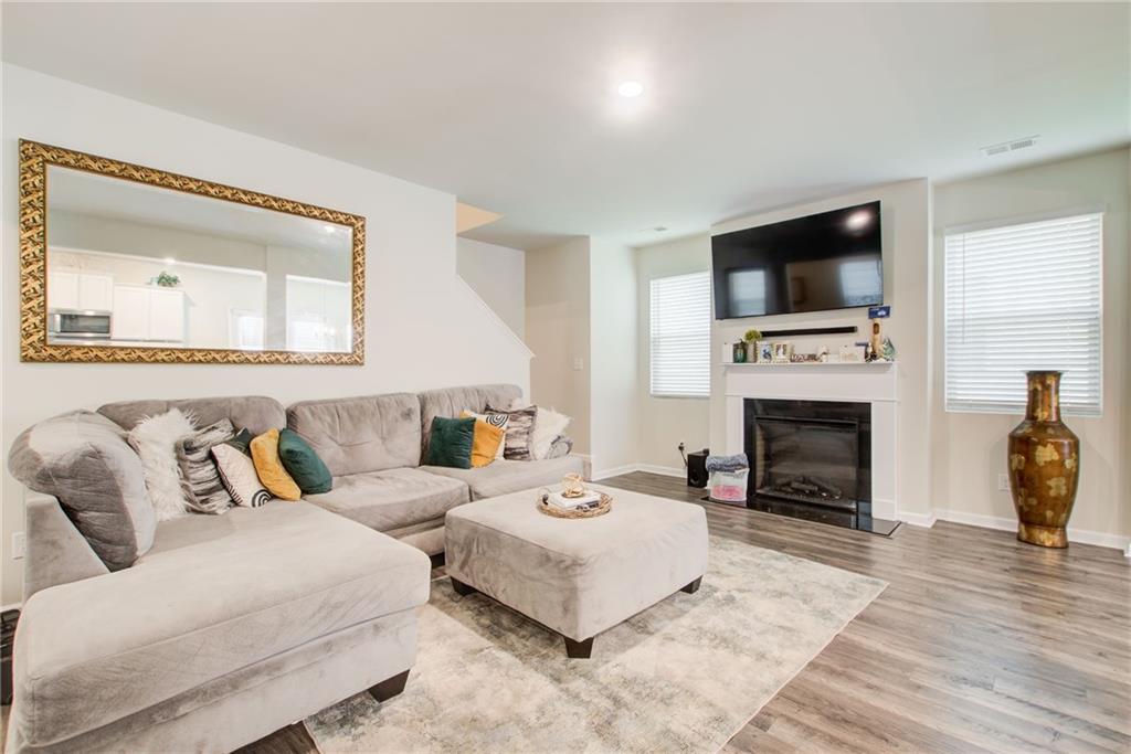 11898 Lovejoy Crossing Boulevard Hampton, GA 30228 - Photo 11 of 30 a living room with furniture a fireplace and a flat screen tv