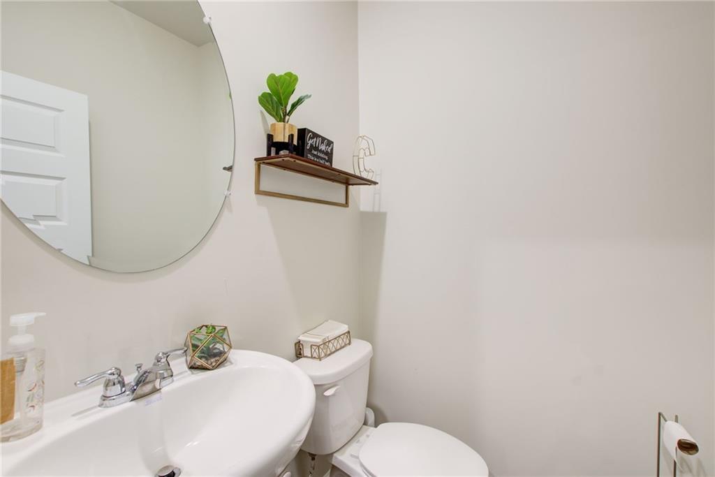 11898 Lovejoy Crossing Boulevard Hampton, GA 30228 - Photo 12 of 30 a bathroom with a toilet sink and mirror