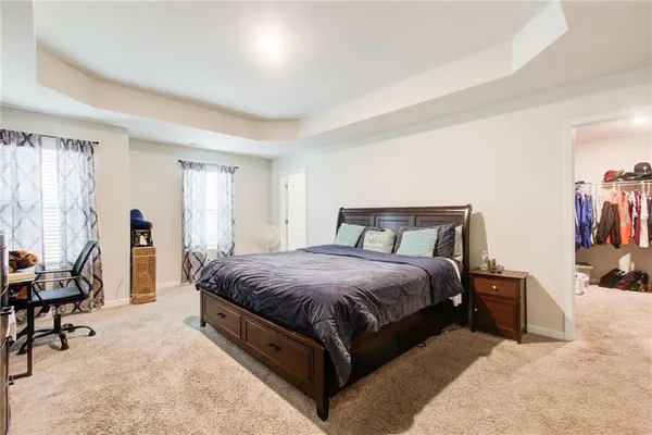 a bed room with a bed and a television