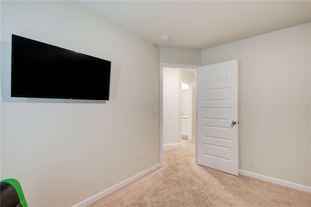 11898 Lovejoy Crossing Boulevard Hampton, GA 30228 - Photo 25 of 30 a view of room with stairs and a flat screen tv