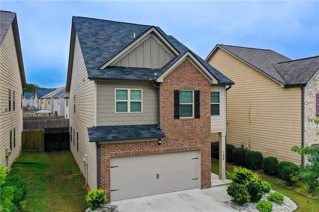 a front view of a building with plants