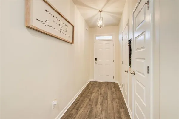 a view of hallway with wooden floor