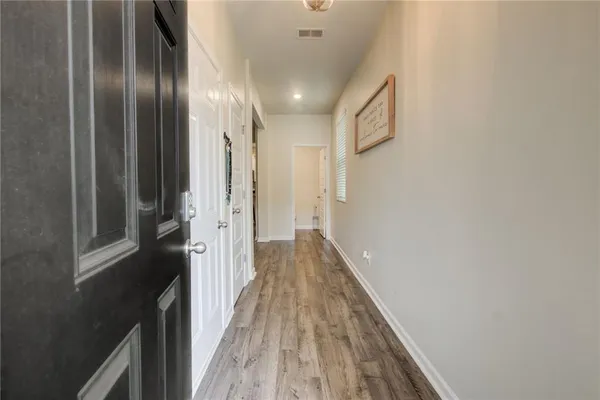 a living room with furniture and a dining table with kitchen view