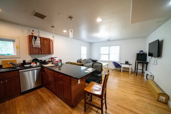 a kitchen with stainless steel appliances granite countertop sink stove top oven and cabinets