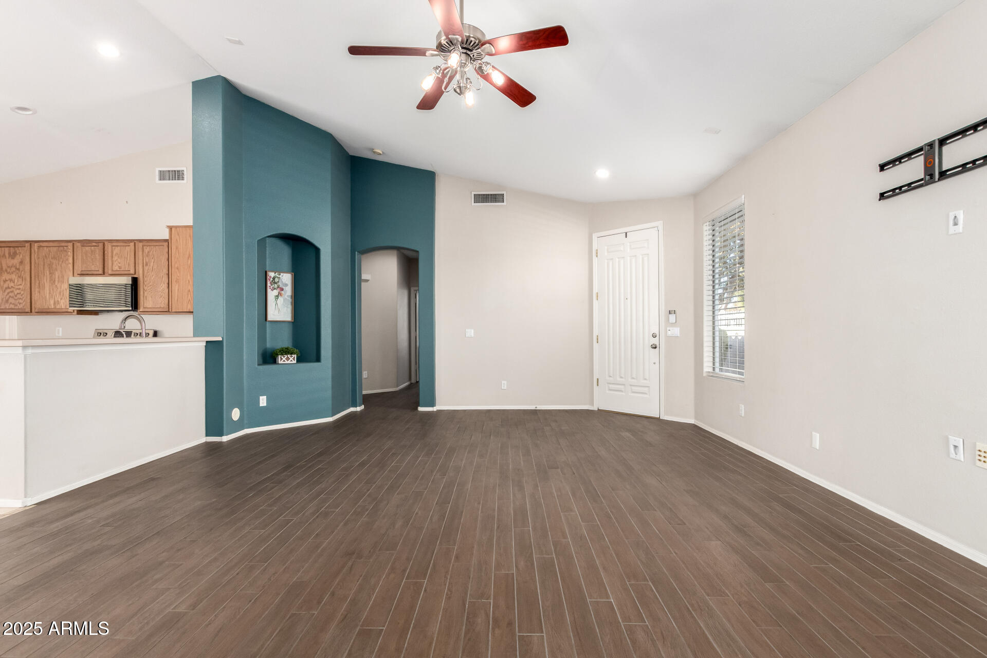 939 South Roca Street Gilbert, AZ 85296 - Photo 11 of 40 a view of a kitchen with wooden floor and a ceiling fan