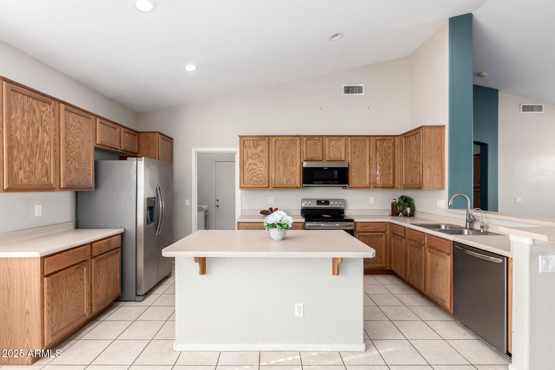 939 South Roca Street Gilbert, AZ 85296 - Photo 13 of 40 a kitchen with a sink a stove top oven and refrigerator