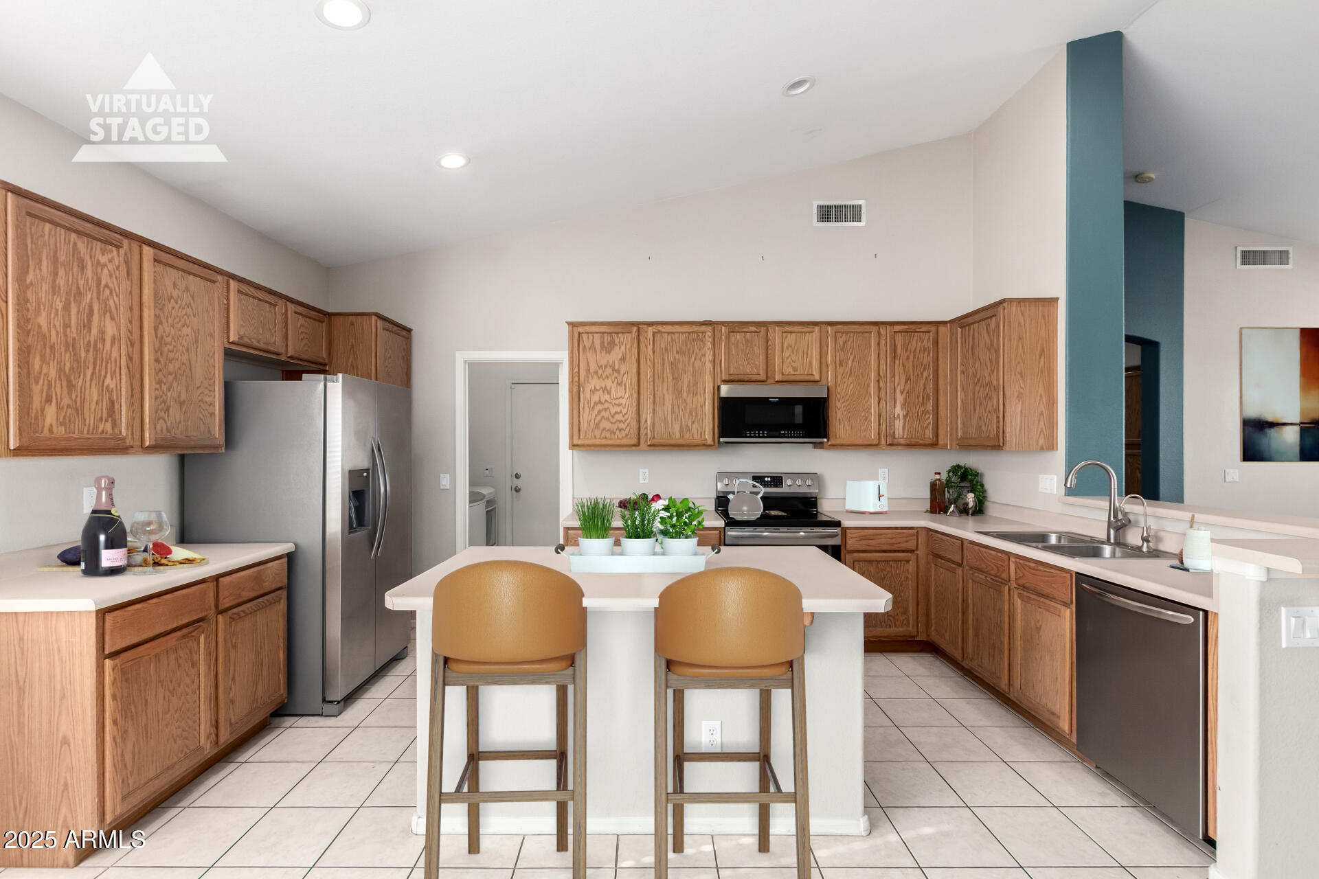 939 South Roca Street Gilbert, AZ 85296 - Photo 14 of 40 a kitchen with stainless steel appliances granite countertop a stove a sink dishwasher and a refrigerator with wooden cabinets