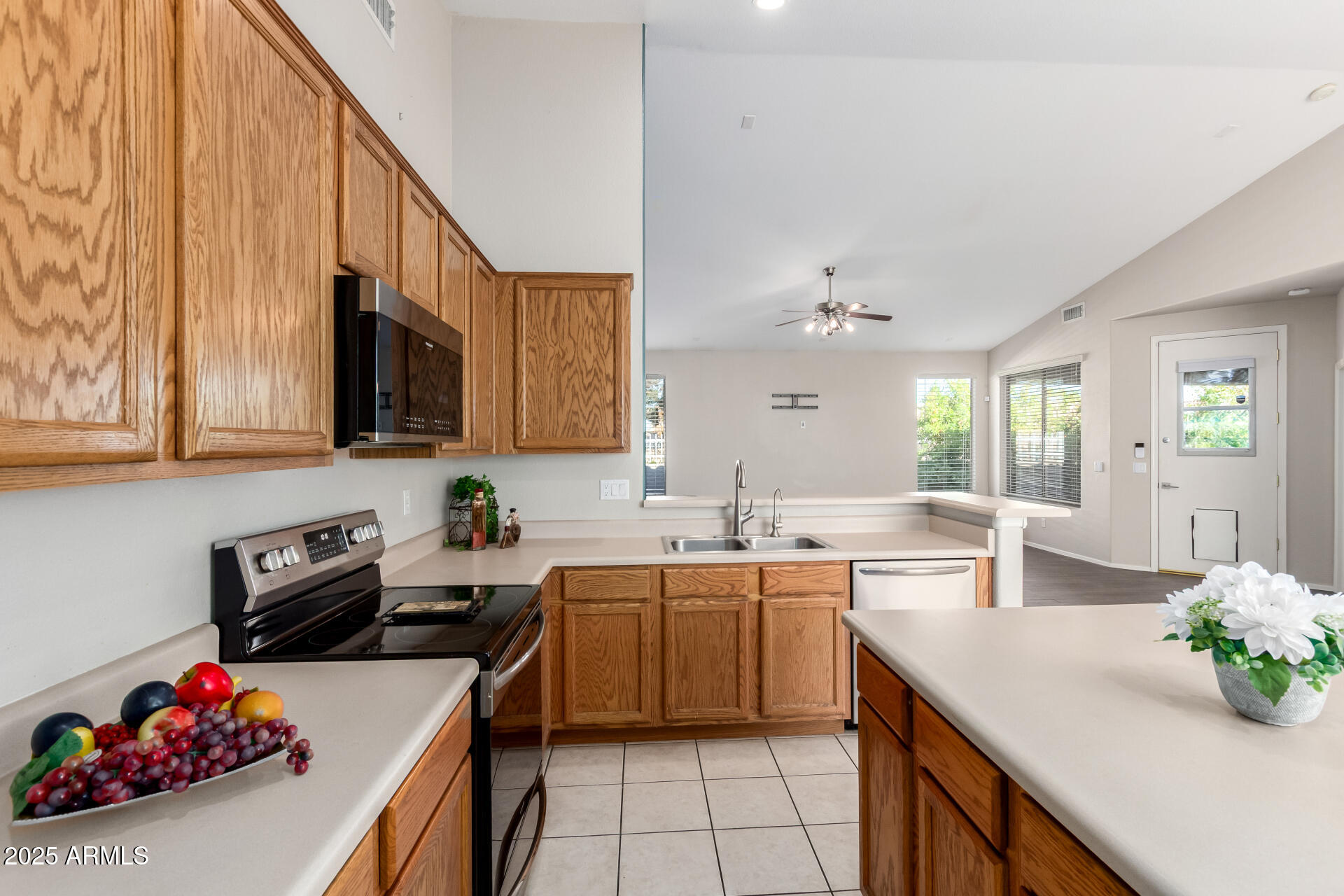 939 South Roca Street Gilbert, AZ 85296 - Photo 16 of 40 a kitchen with a sink a stove and cabinets