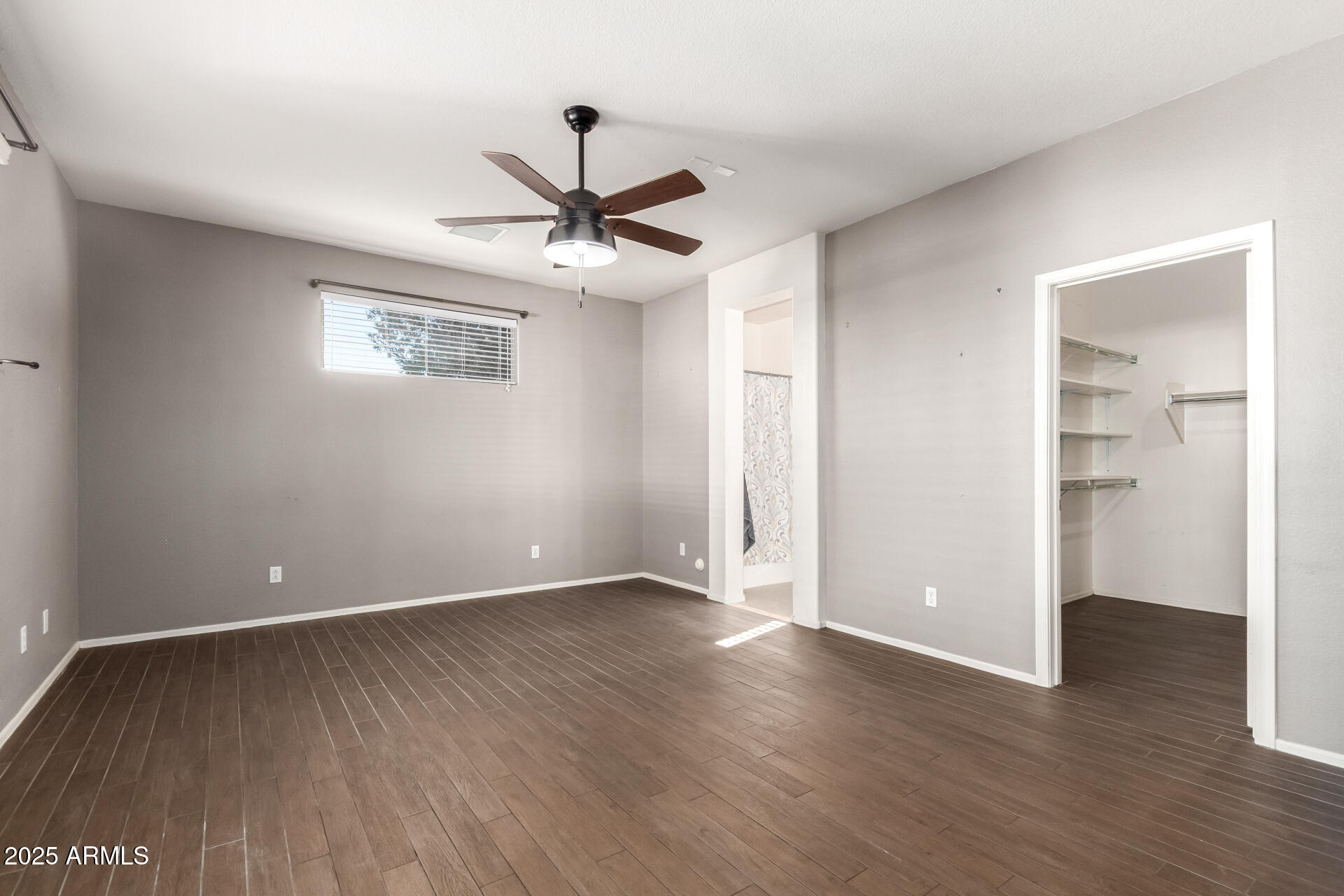 939 South Roca Street Gilbert, AZ 85296 - Photo 19 of 40 an empty room with wooden floor ceiling fan and windows