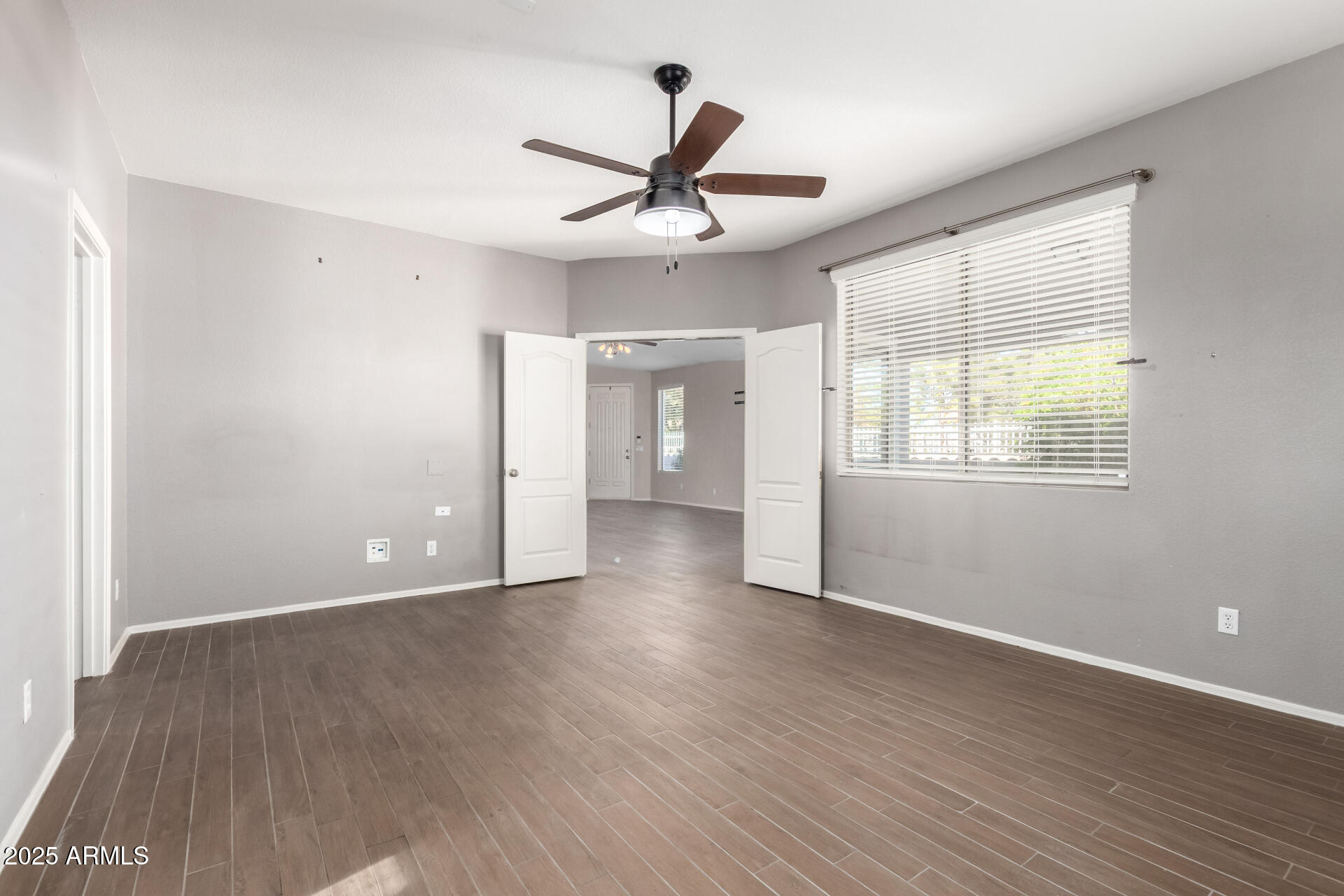 939 South Roca Street Gilbert, AZ 85296 - Photo 21 of 40 a view of empty room with wooden floor and fan