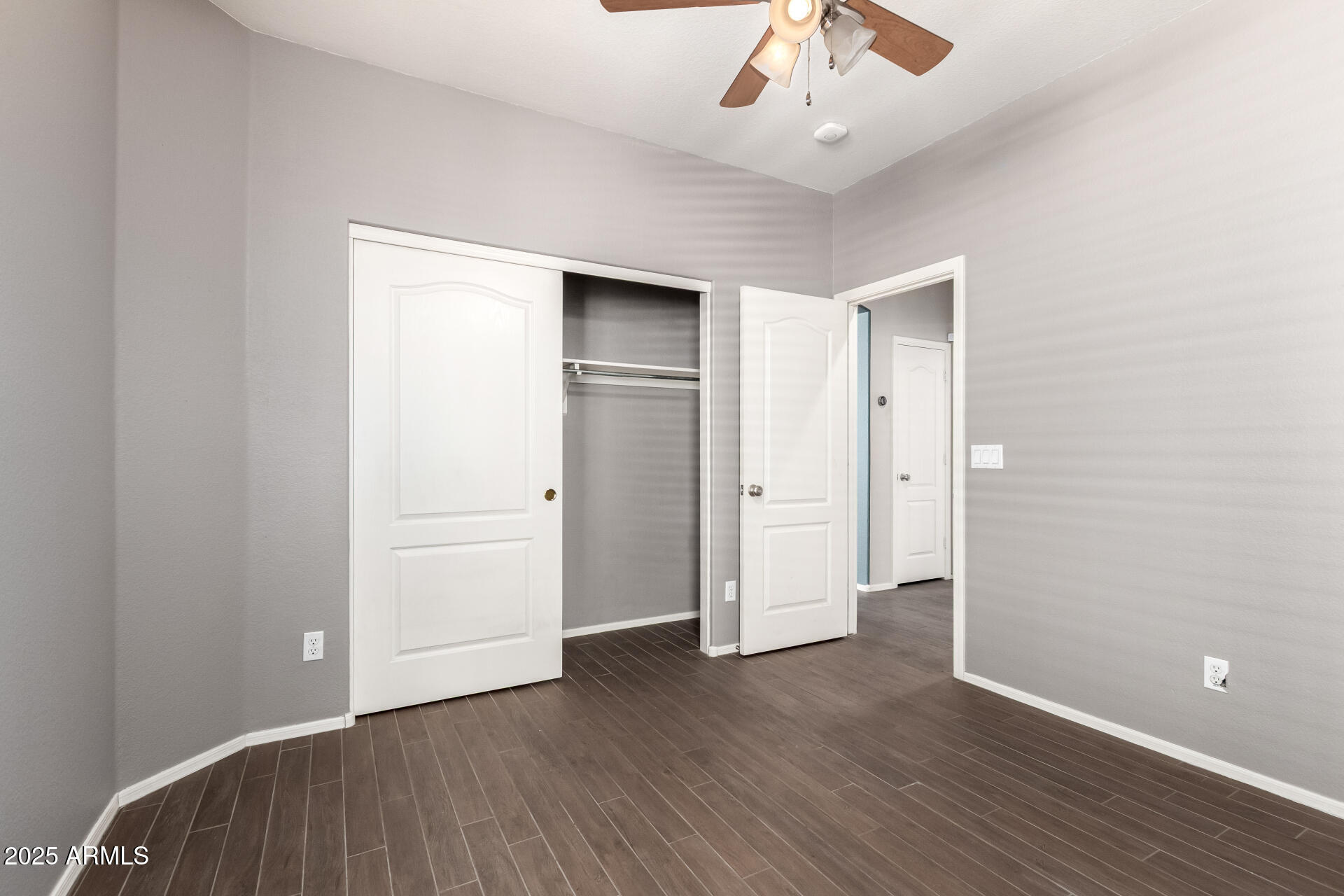 939 South Roca Street Gilbert, AZ 85296 - Photo 25 of 40 an empty room with wooden floor and ceiling fan