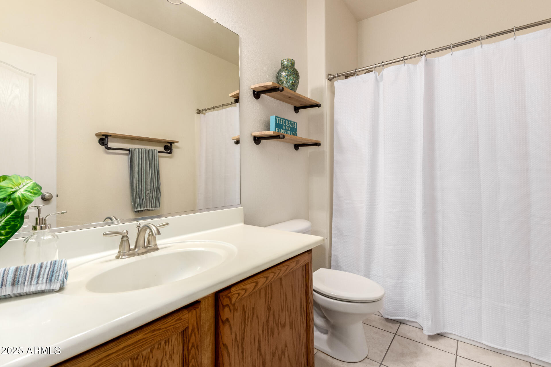 939 South Roca Street Gilbert, AZ 85296 - Photo 26 of 40 a bathroom with a granite countertop sink toilet and a mirror