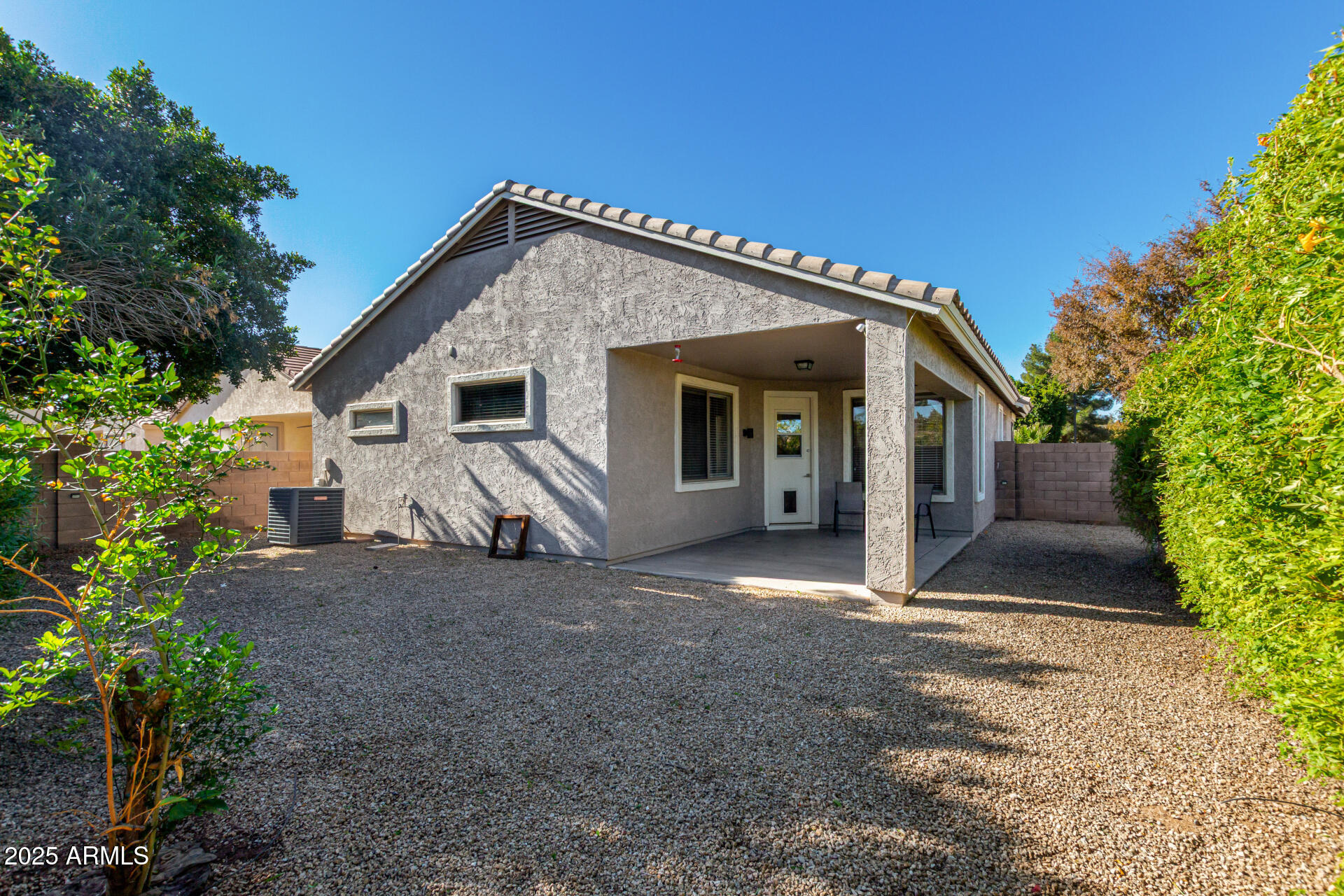 939 South Roca Street Gilbert, AZ 85296 - Photo 30 of 40 a view of a house with backyard and trees