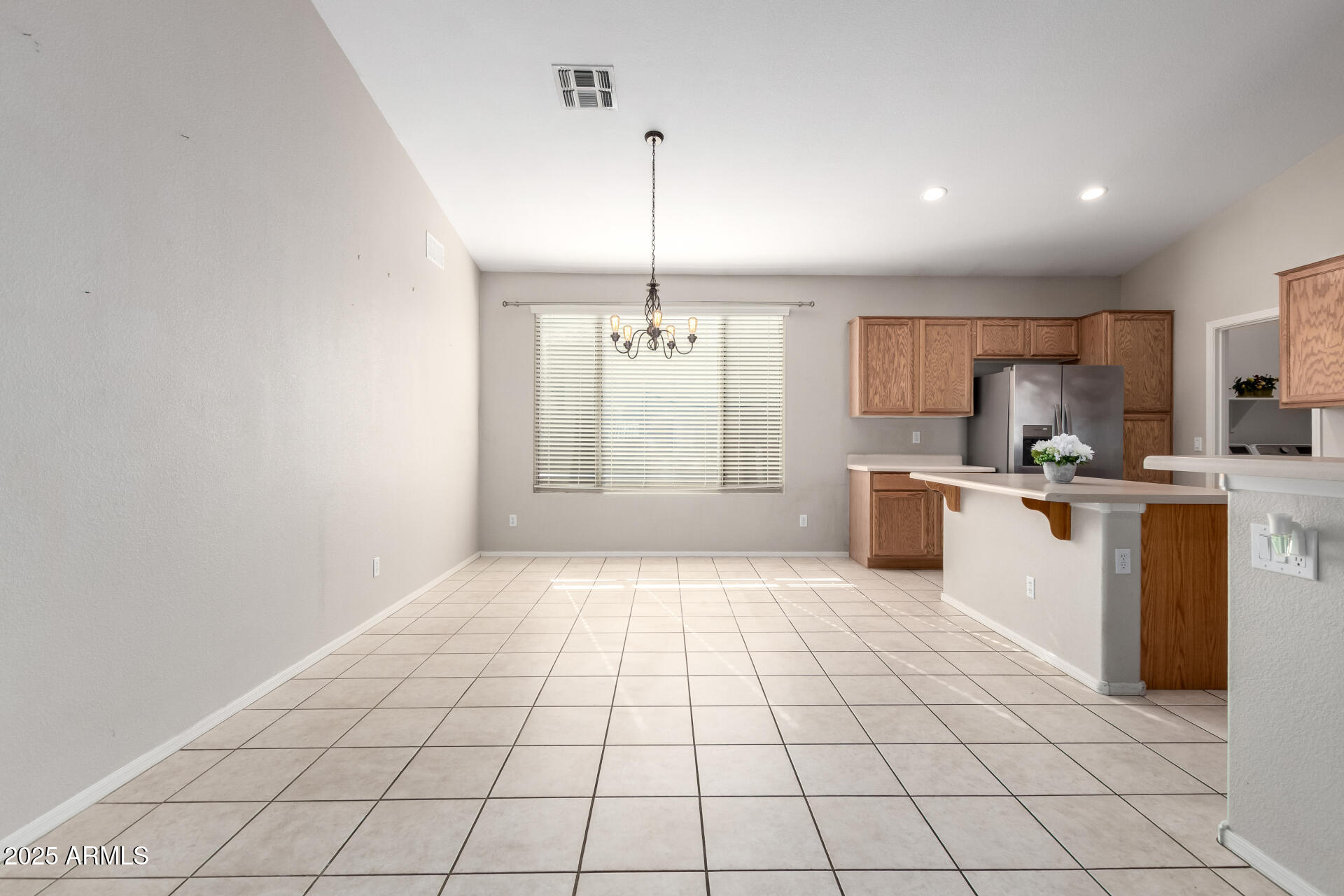 939 South Roca Street Gilbert, AZ 85296 - Photo 10 of 40 a large white kitchen with cabinets