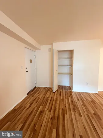 a view of a room with wooden floor and cabinet