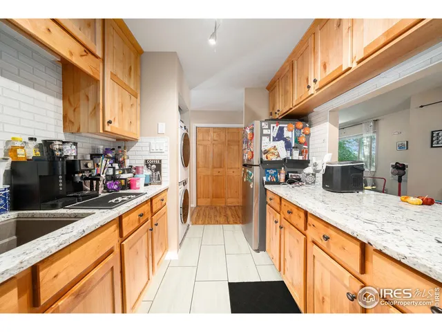 a kitchen with stainless steel appliances kitchen island granite countertop a sink and cabinets