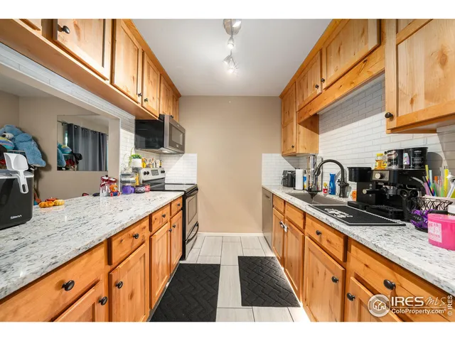 a kitchen with stainless steel appliances granite countertop a sink and cabinets