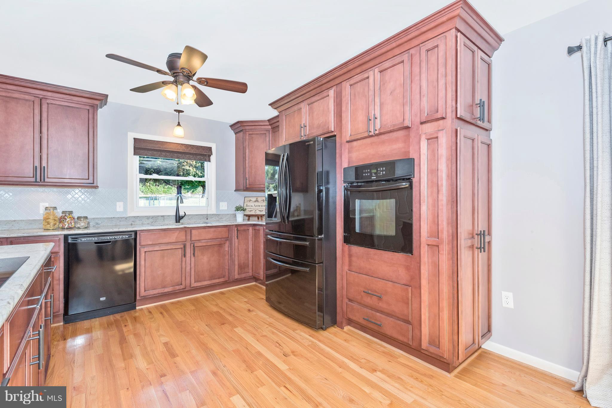 7311 Ridge Road Frederick, MD 21702 - Photo 11 of 30 a kitchen with stainless steel appliances a refrigerator and a stove top oven