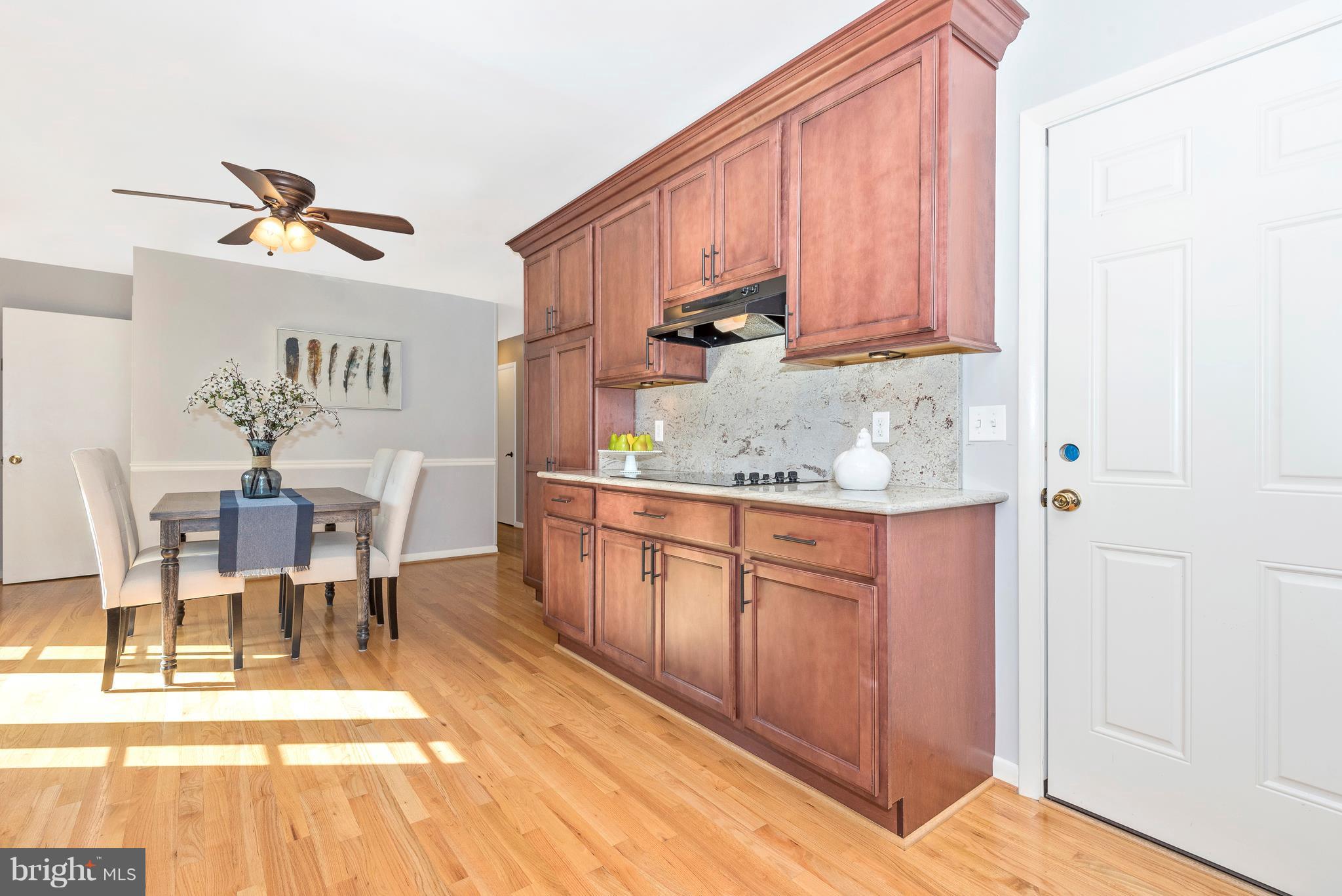 7311 Ridge Road Frederick, MD 21702 - Photo 12 of 30 a kitchen with stainless steel appliances granite countertop a stove a sink dishwasher and a cabinets with wooden floor