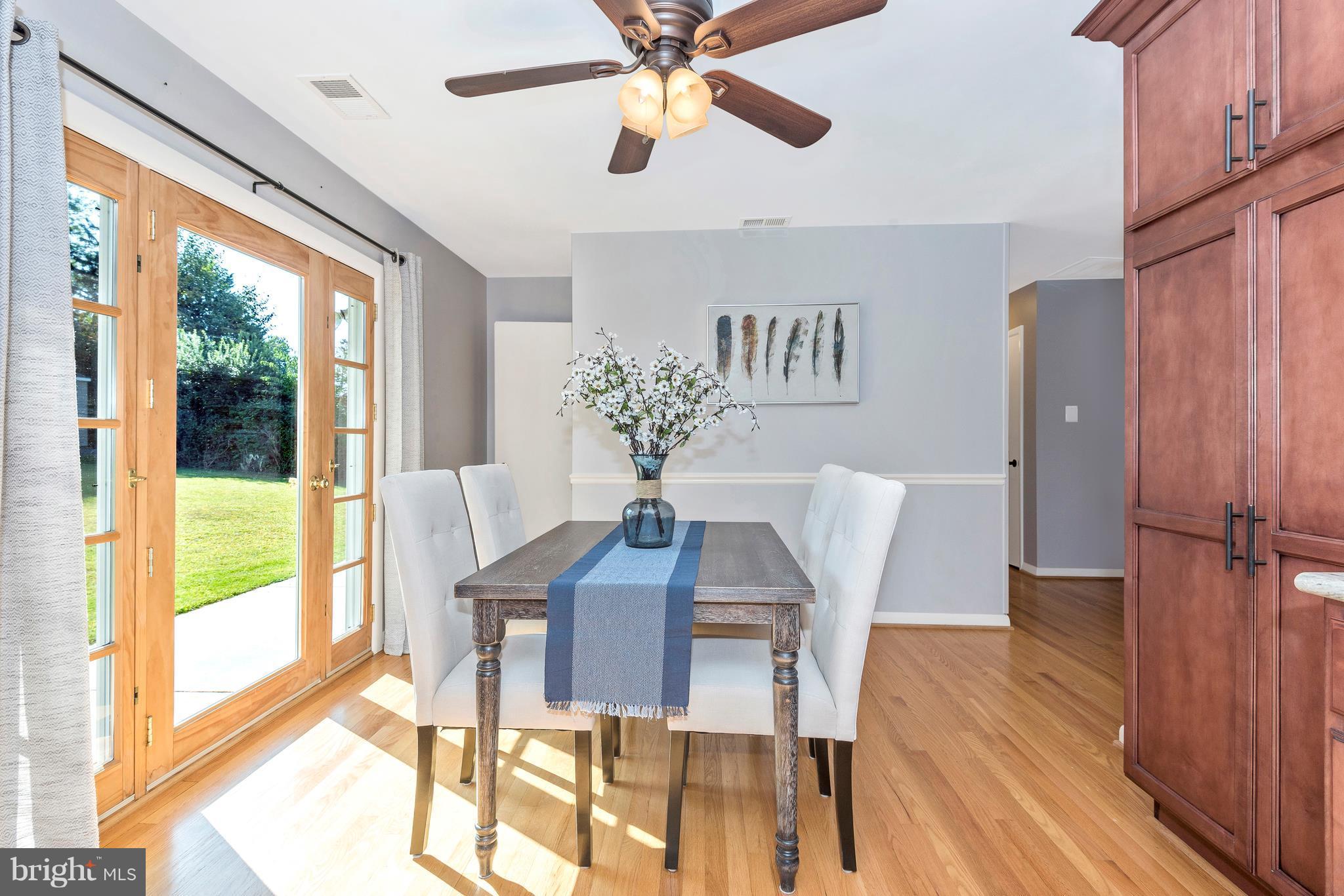 7311 Ridge Road Frederick, MD 21702 - Photo 13 of 30 a dining room with furniture a chandelier and wooden floor