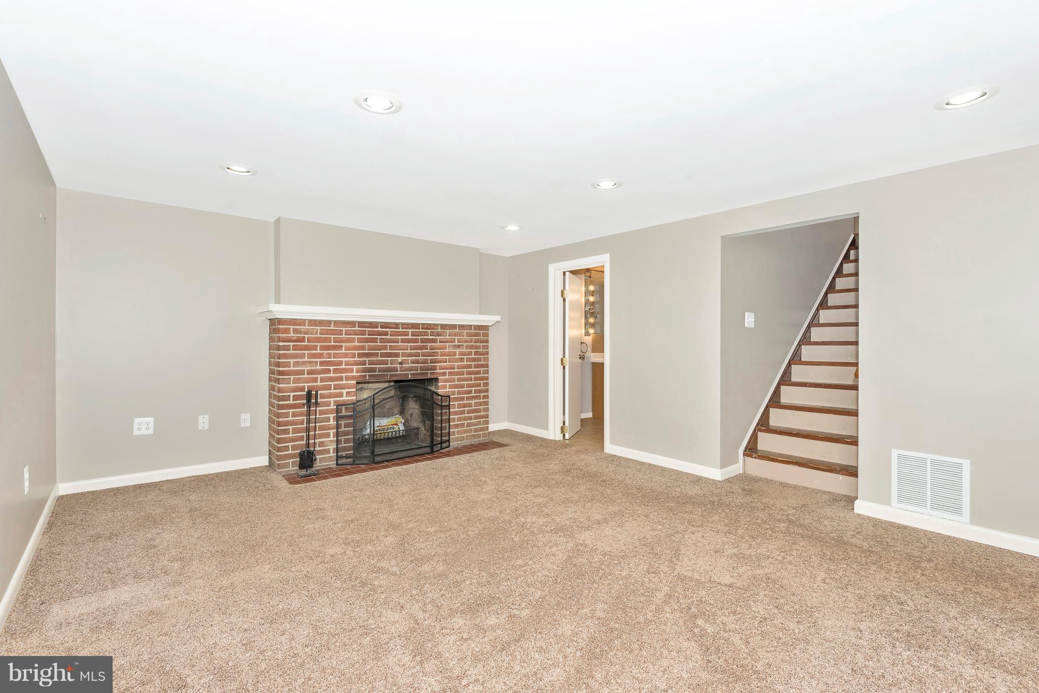 7311 Ridge Road Frederick, MD 21702 - Photo 23 of 30 an empty room with fireplace and windows