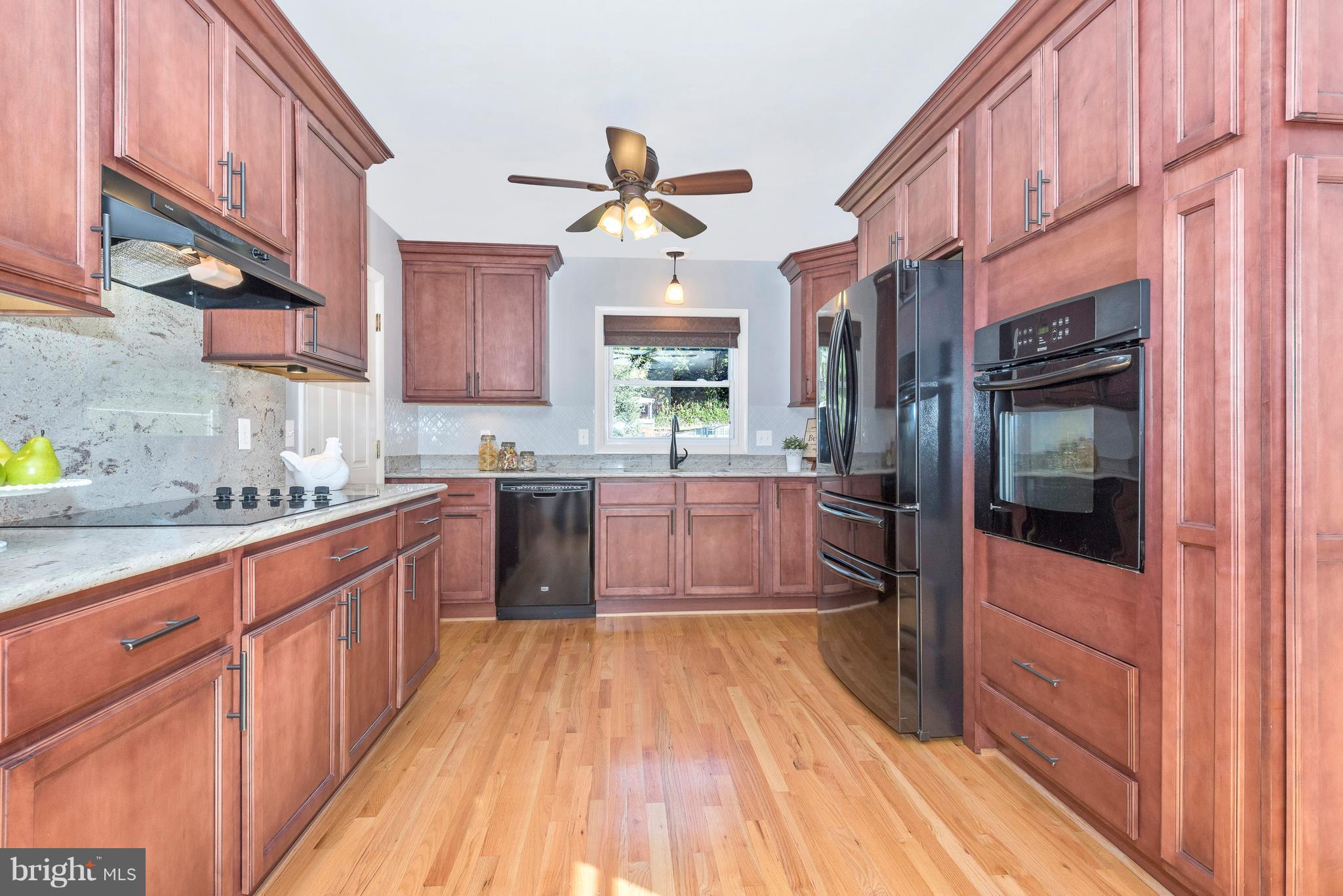 7311 Ridge Road Frederick, MD 21702 - Photo 9 of 30 a kitchen with stainless steel appliances granite countertop a stove a sink and a refrigerator