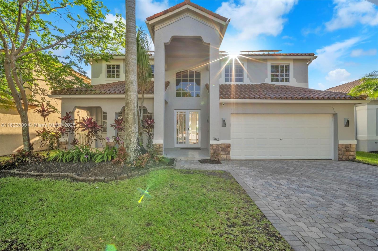 942 Lavender Circle Weston, FL 33327 - Photo 2 of 68 a front view of a house with a garden and yard