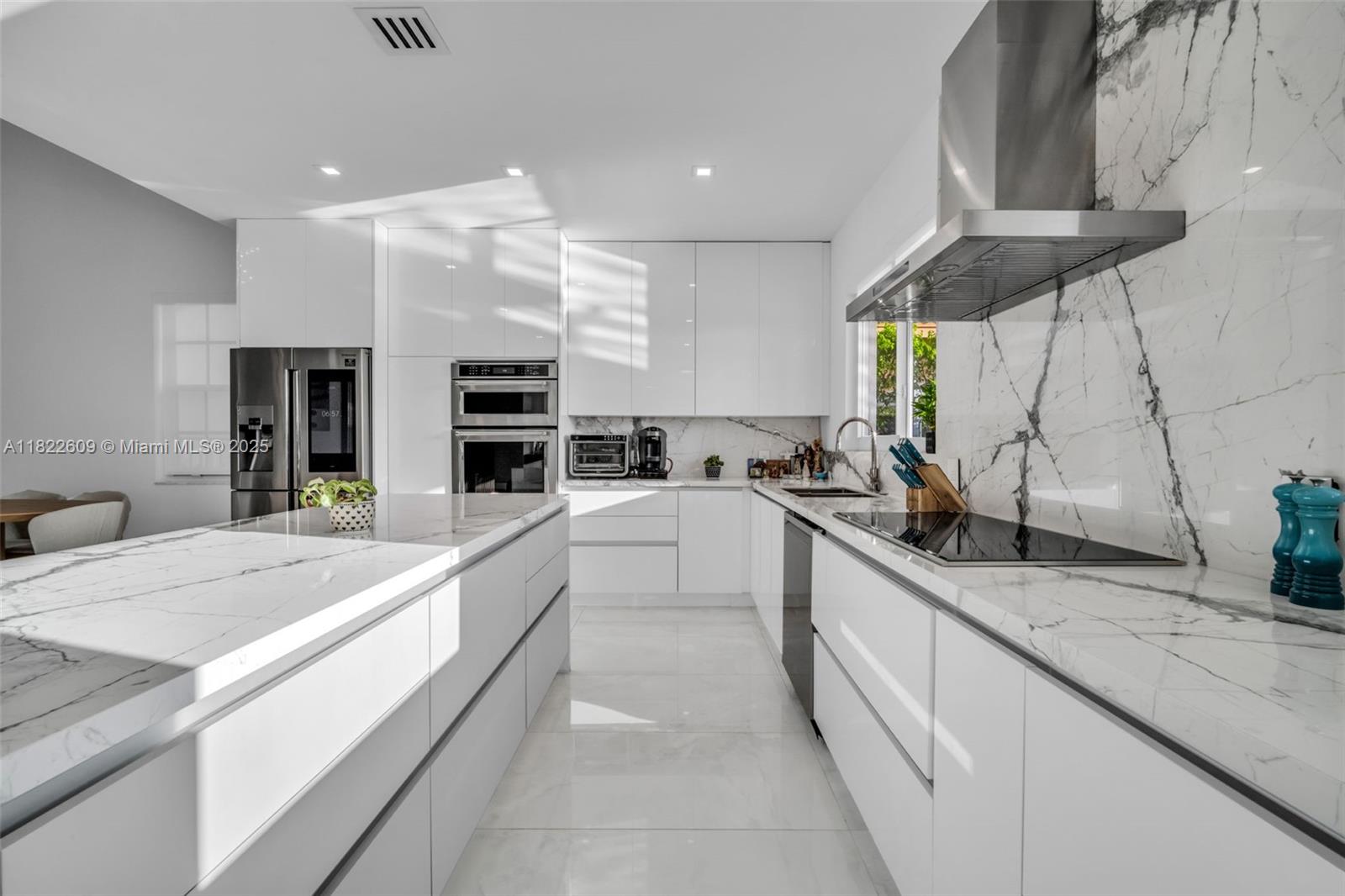 942 Lavender Circle Weston, FL 33327 - Photo 22 of 68 a large white kitchen with a large window