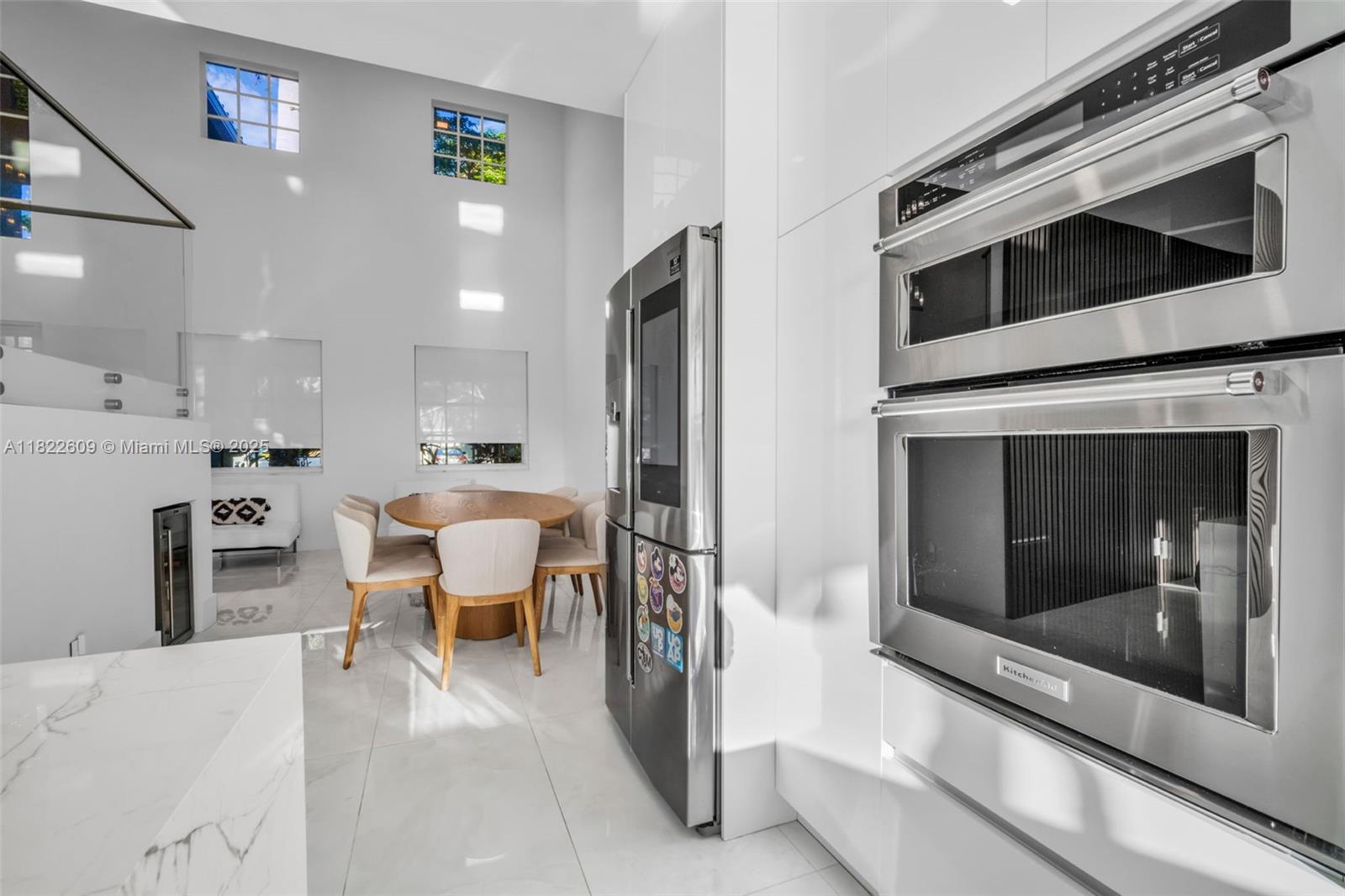 942 Lavender Circle Weston, FL 33327 - Photo 24 of 68 a living room with stainless steel appliances furniture a fireplace and a kitchen view