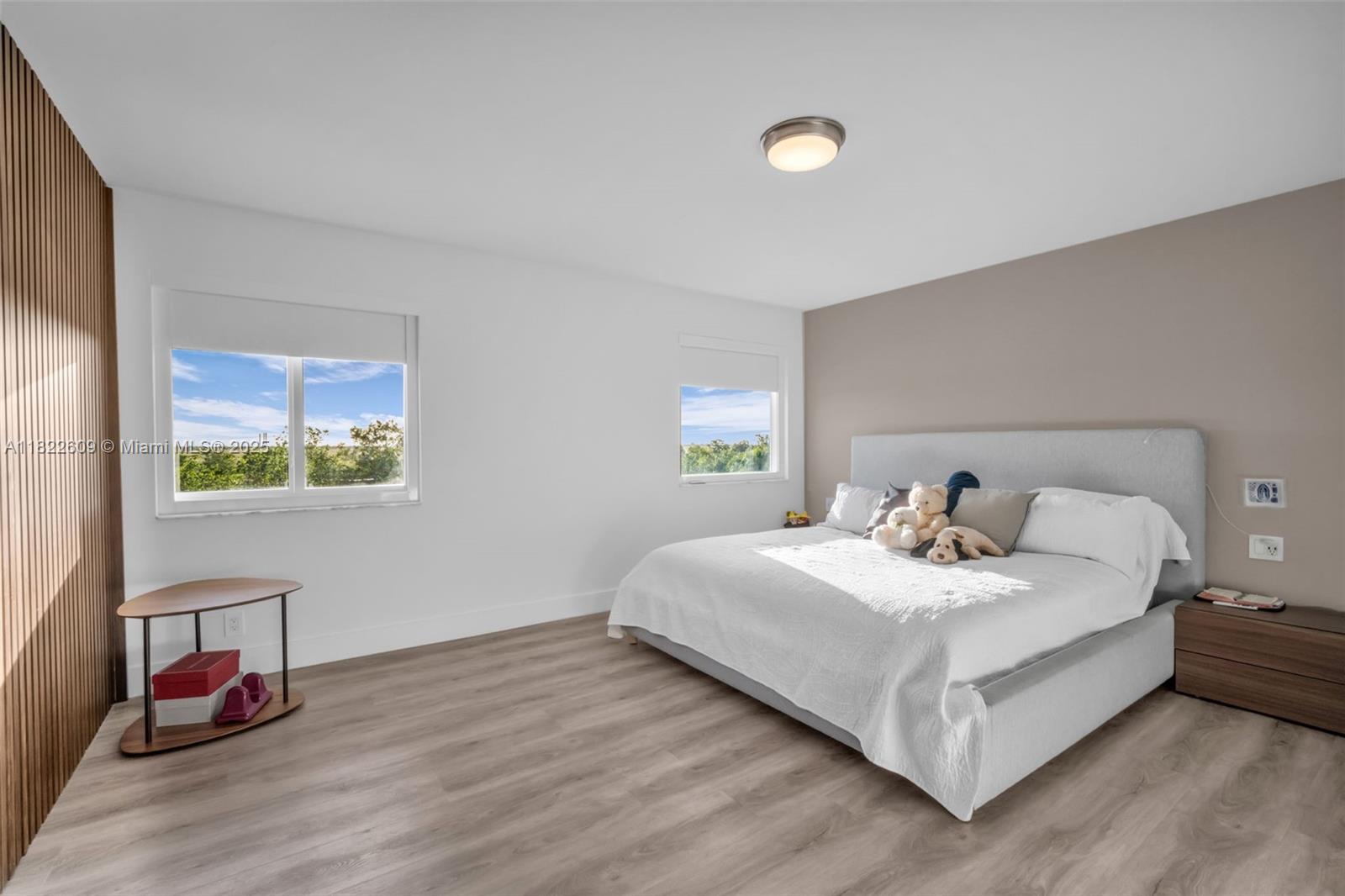 942 Lavender Circle Weston, FL 33327 - Photo 40 of 68 a bedroom with a bed and wooden floor