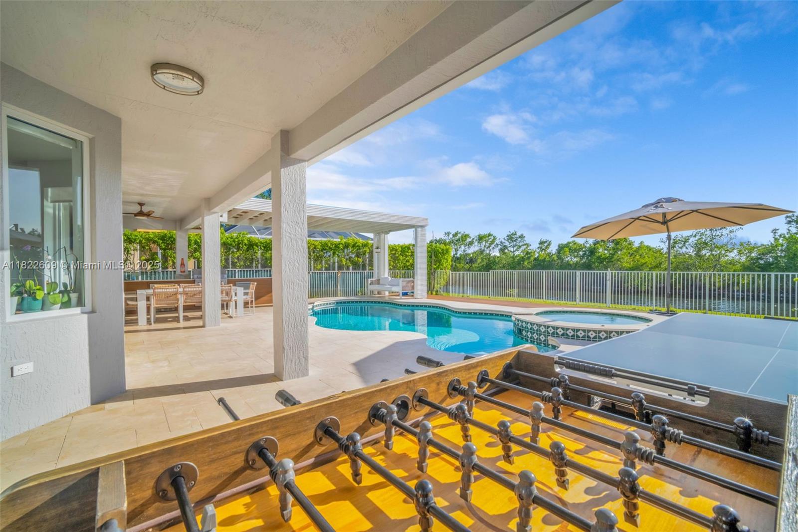 942 Lavender Circle Weston, FL 33327 - Photo 4 of 68 a view of a swimming pool with a patio and a yard