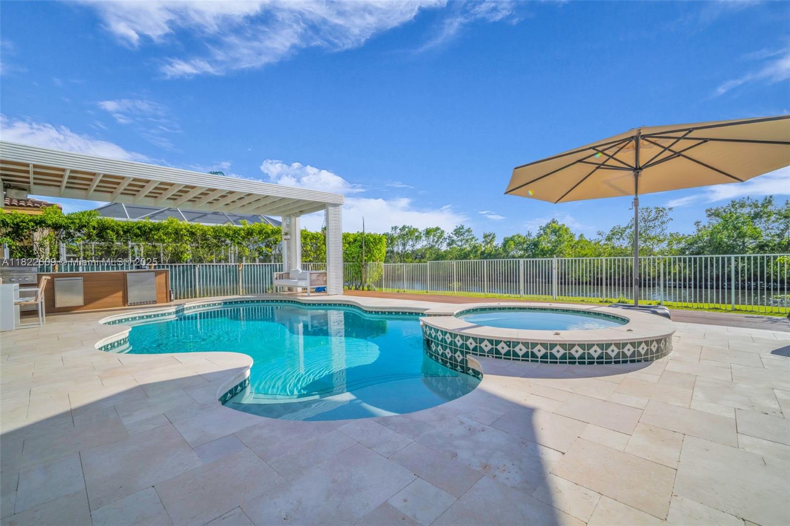 942 Lavender Circle Weston, FL 33327 - Photo 5 of 68 a view of a swimming pool with a patio