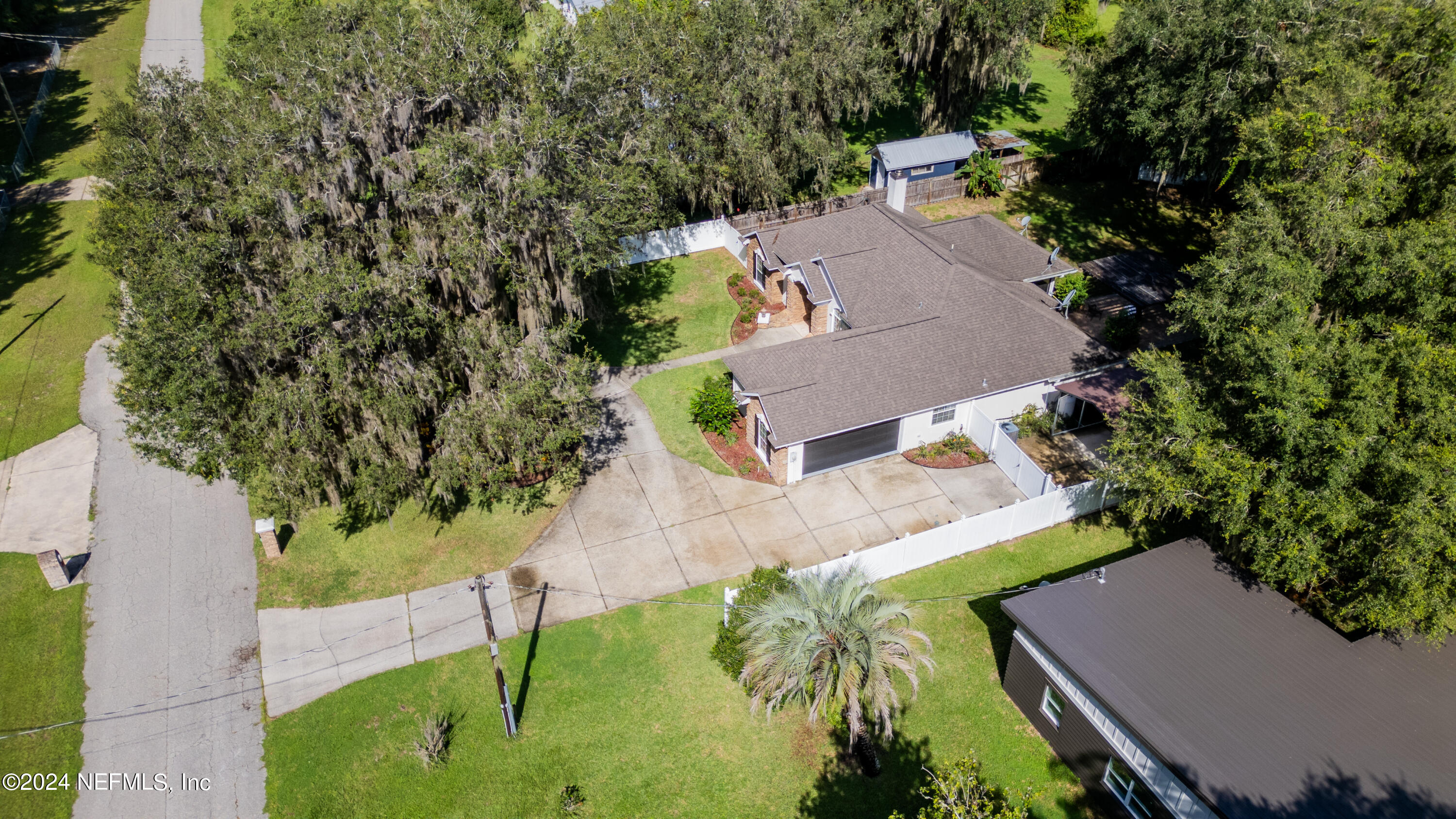 112 Eberhard Avenue Palatka, FL 32177 - Photo 12 of 48 an aerial view of a house with a yard and trees all around