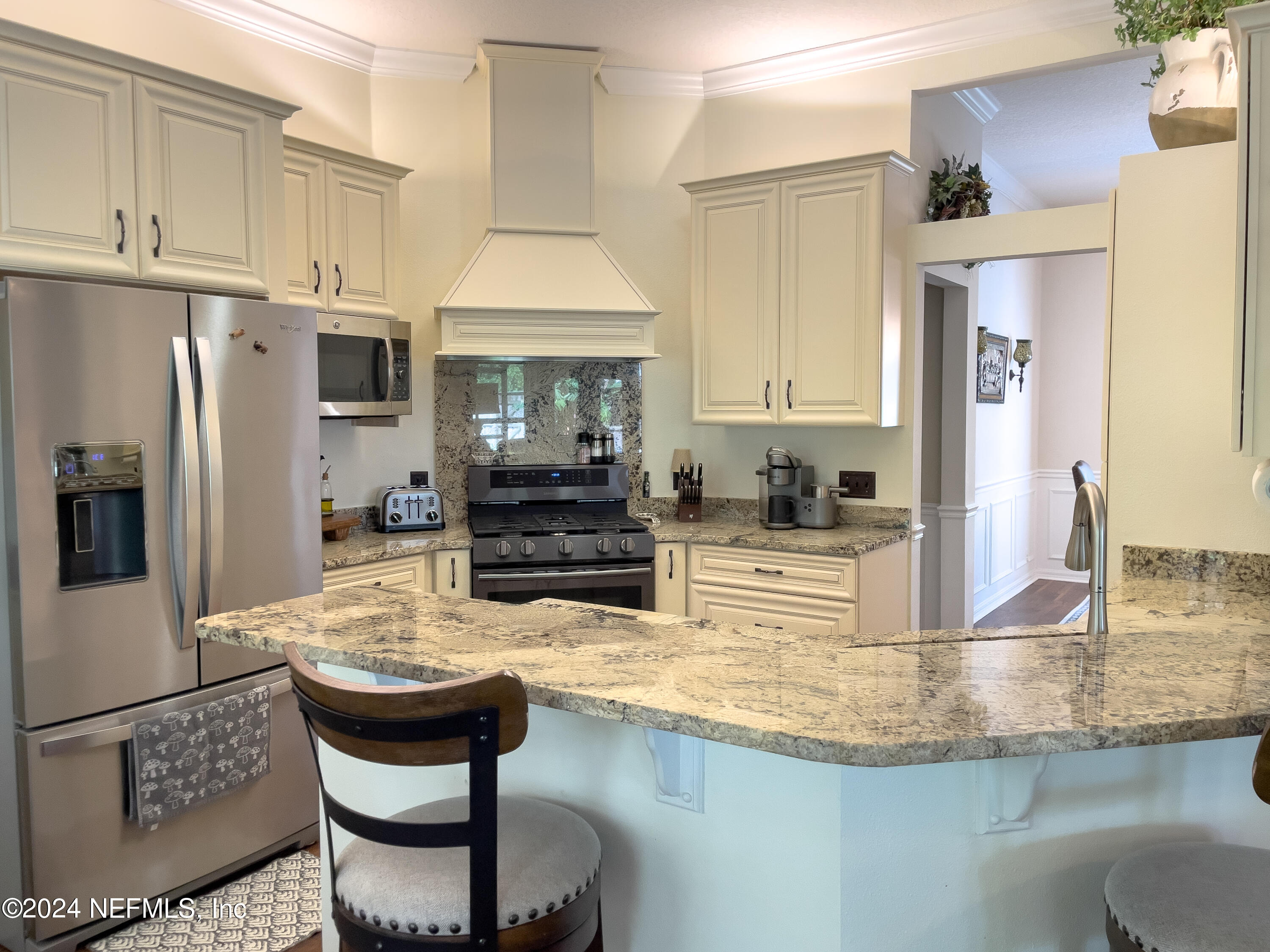 112 Eberhard Avenue Palatka, FL 32177 - Photo 27 of 48 a kitchen with kitchen island granite countertop a stove cabinets and refrigerator