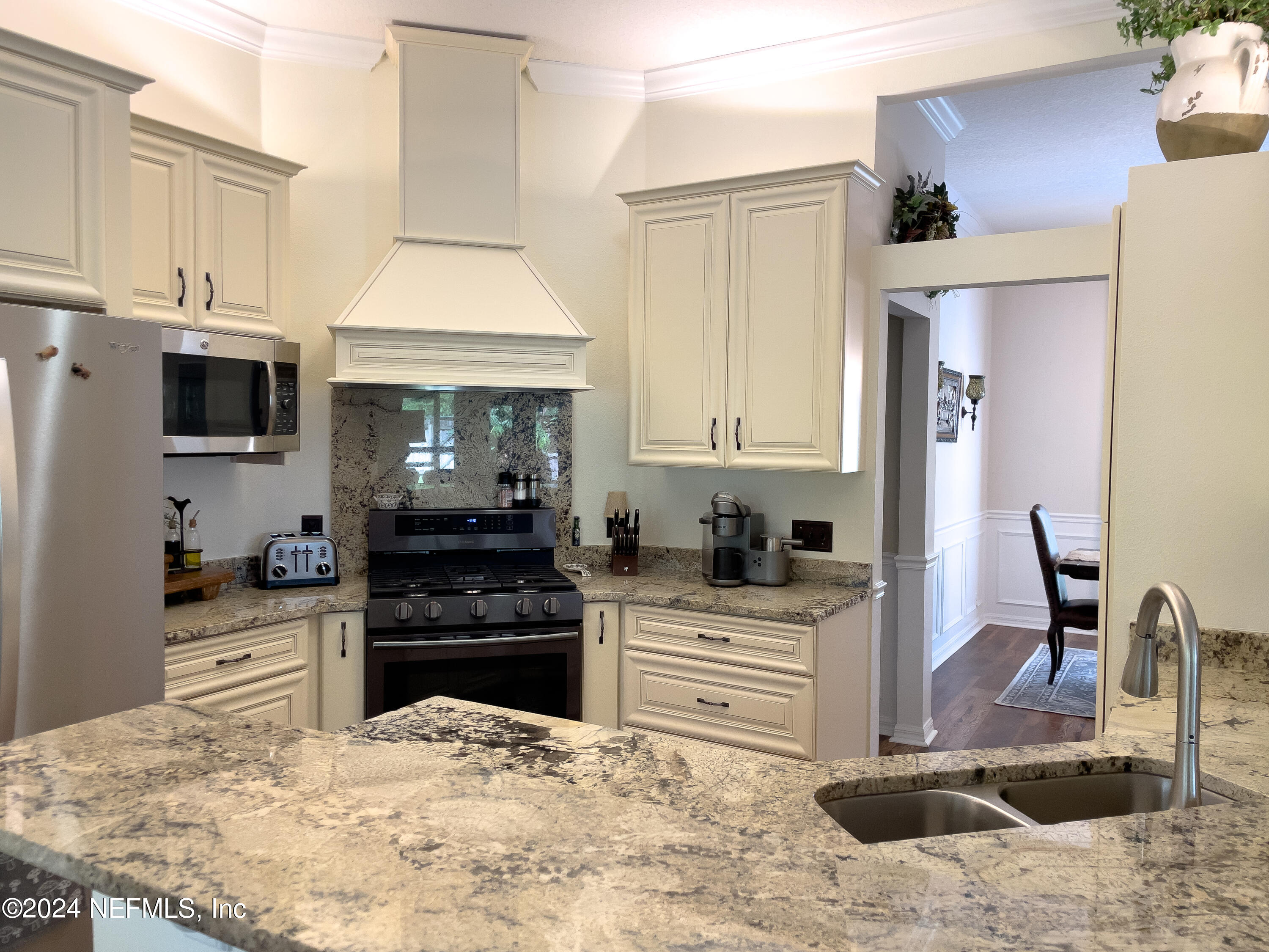 112 Eberhard Avenue Palatka, FL 32177 - Photo 28 of 48 a kitchen with stainless steel appliances kitchen island granite countertop a stove top oven a sink a counter space and cabinets