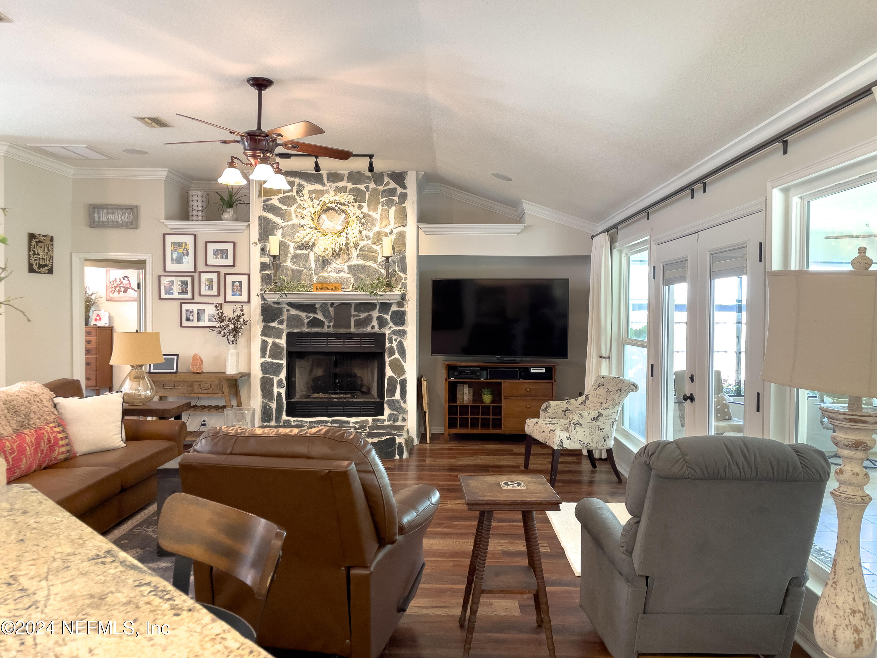 112 Eberhard Avenue Palatka, FL 32177 - Photo 32 of 48 a living room with furniture a flat screen tv and a fireplace