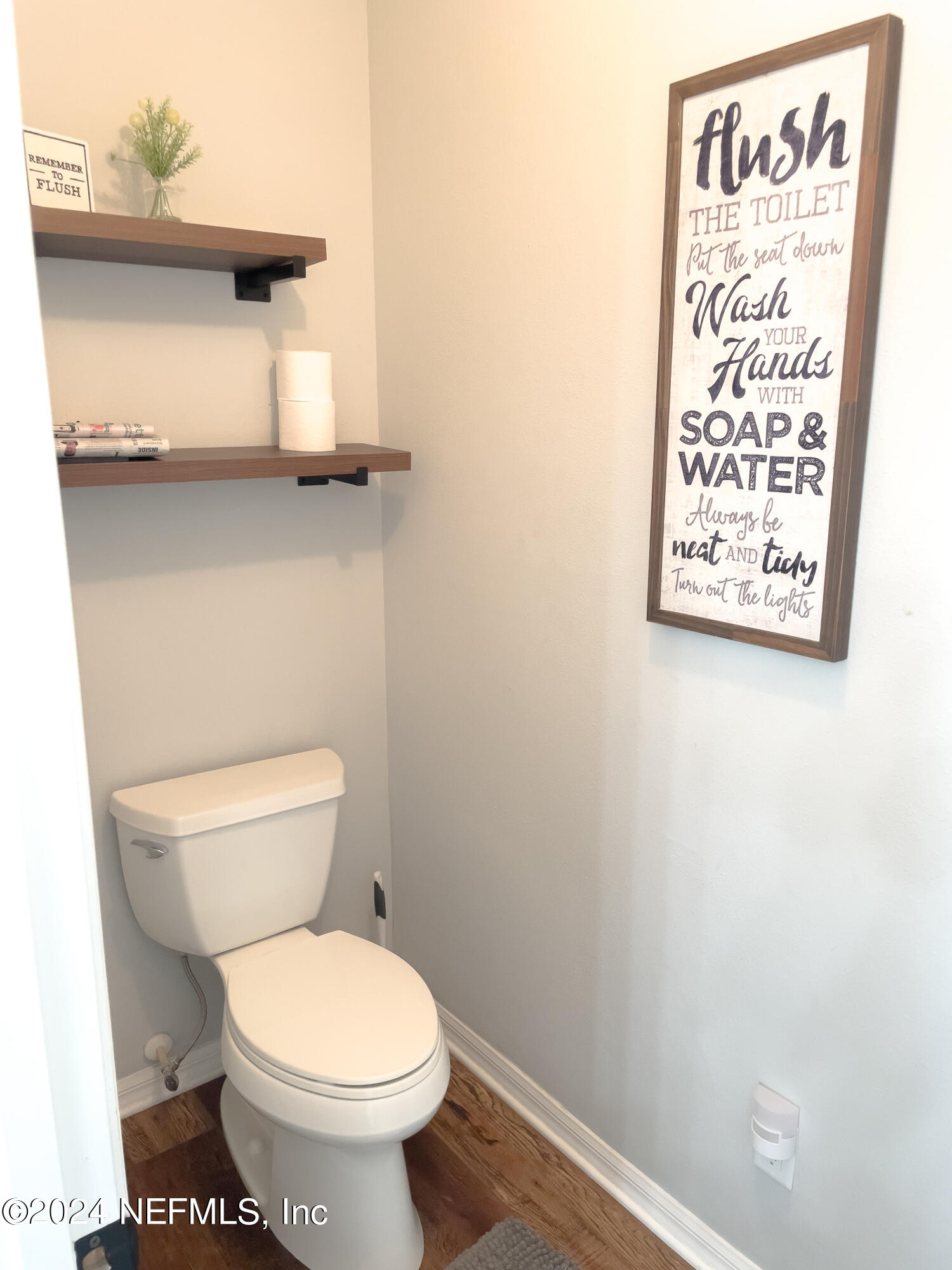 112 Eberhard Avenue Palatka, FL 32177 - Photo 42 of 48 a bathroom with a toilet and a picture on the wall