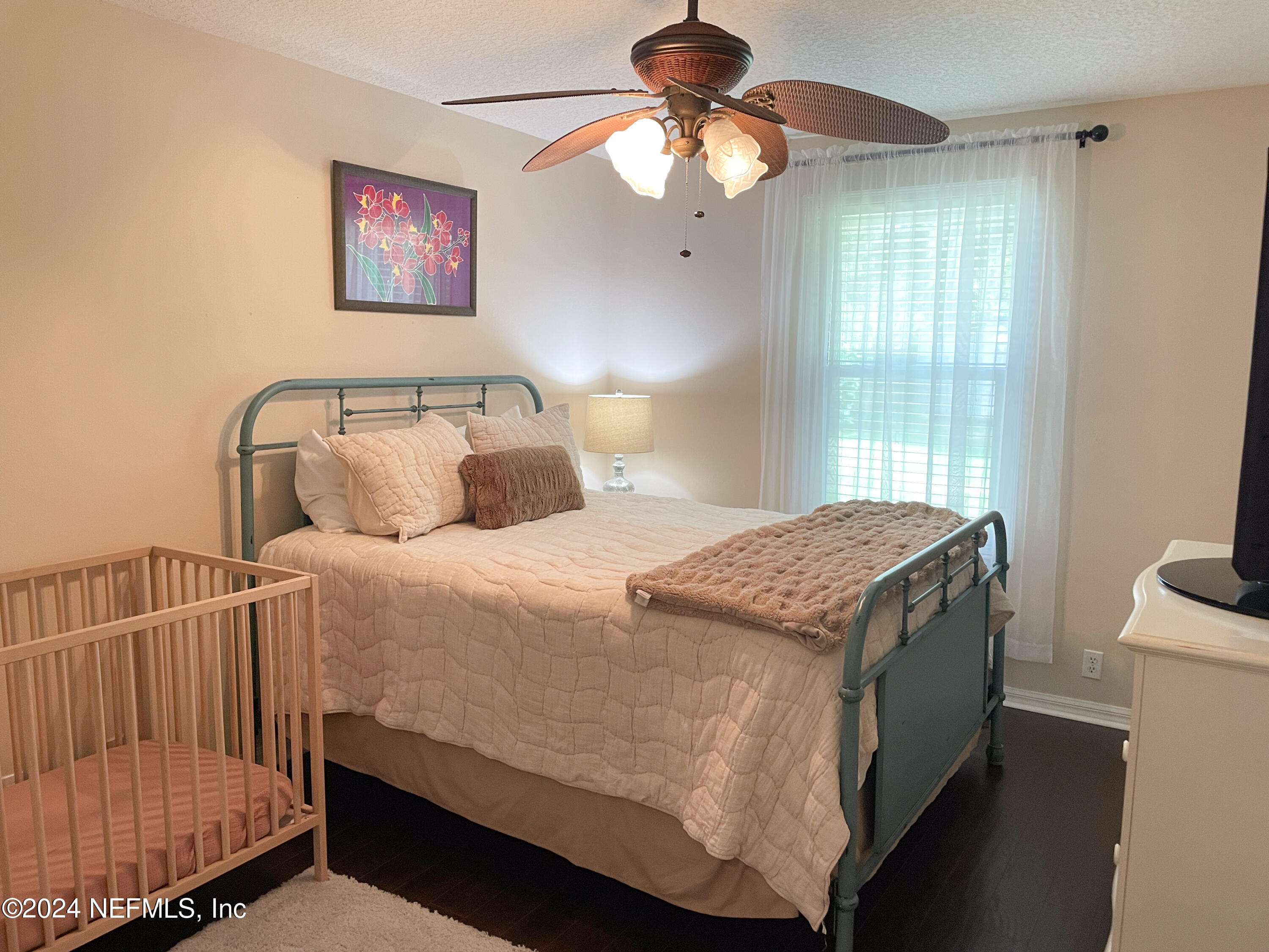 112 Eberhard Avenue Palatka, FL 32177 - Photo 45 of 48 a bedroom with a bed and a chandelier